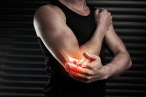 Shot of an unrecognizable young man with an elbow injury in the studio